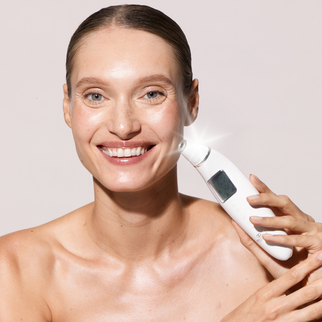 A model demonstrates a Project E Beauty Reinvo microdermabrasion tool as part of a skincare routine